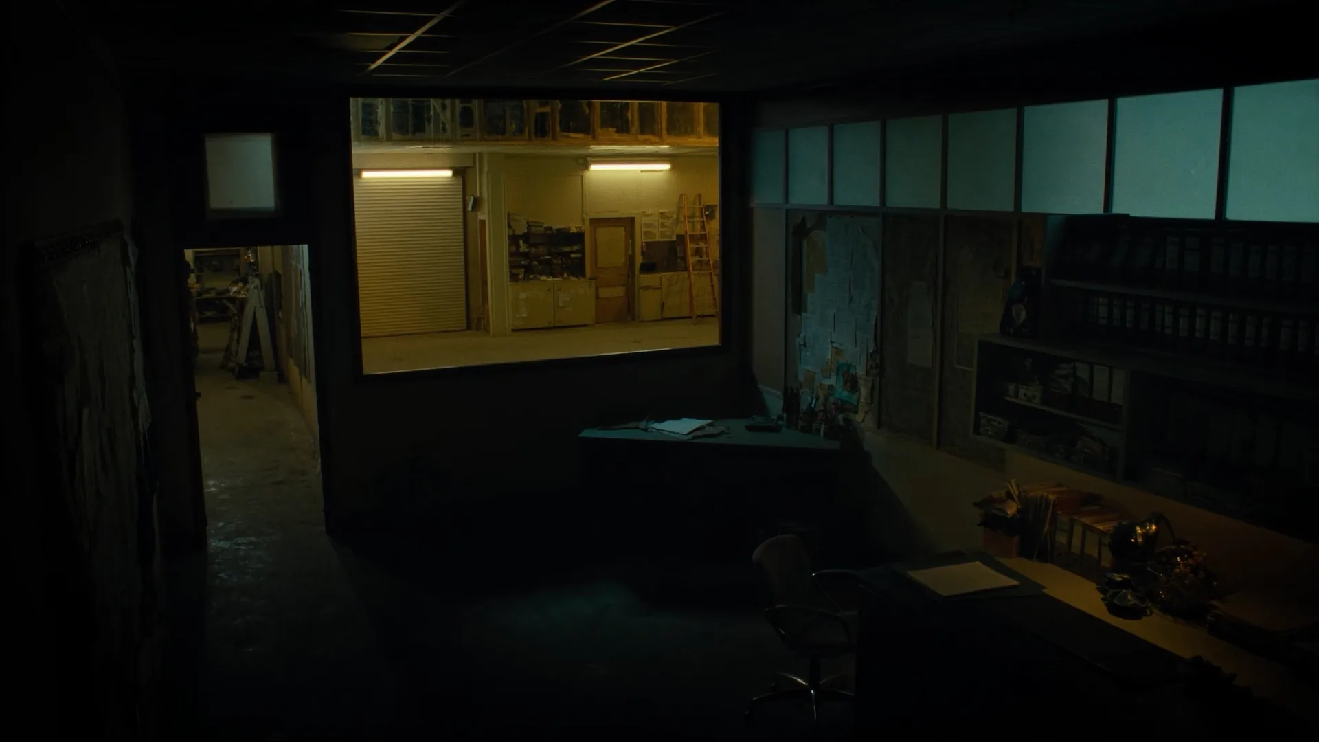 Empty estimator office. Plans and a desk. No product chrome.