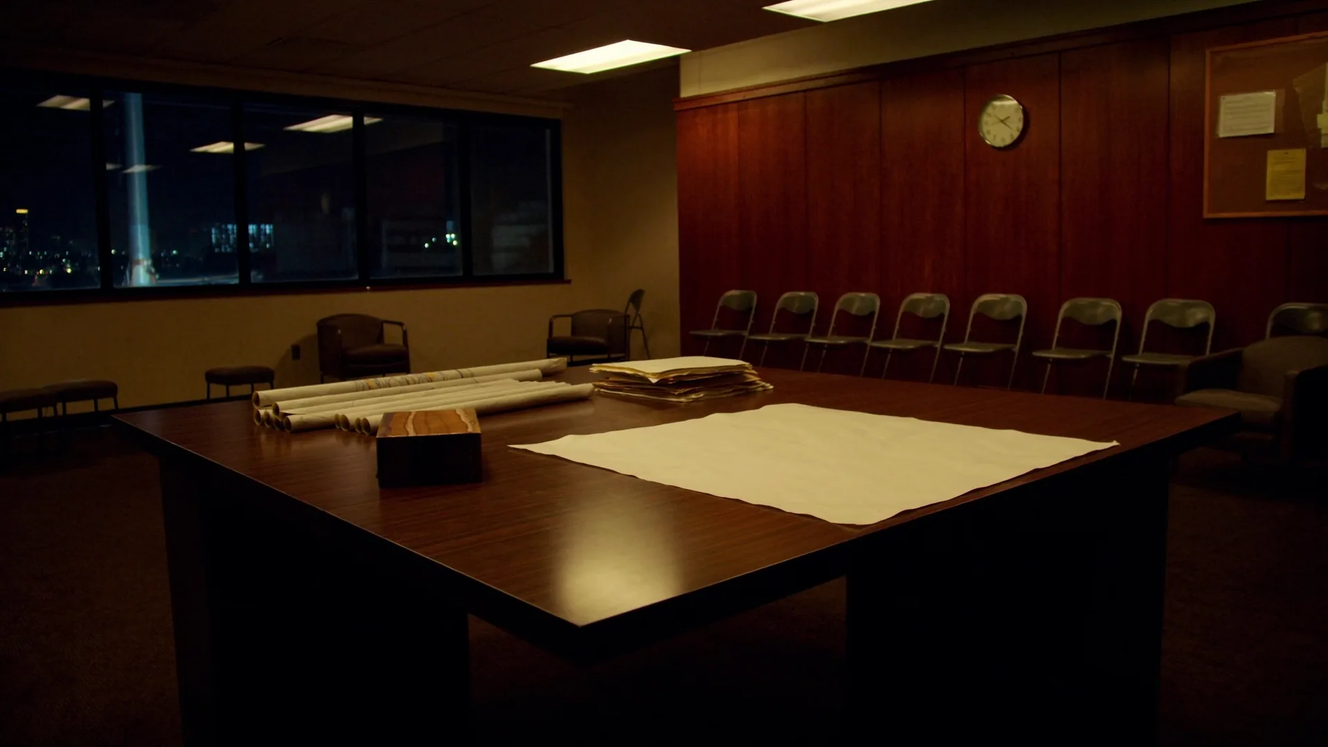 Empty conference table after hours. No screens.