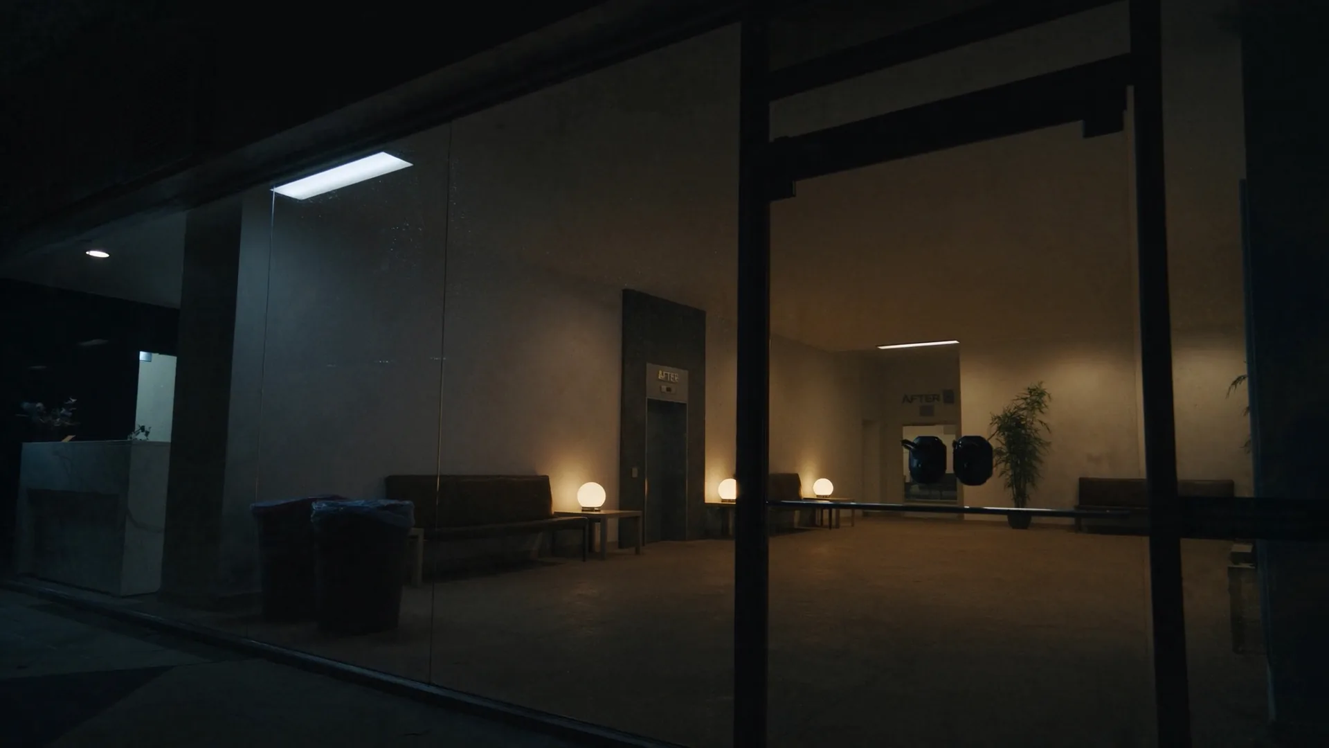 Empty lobby corridor at night. No signage.