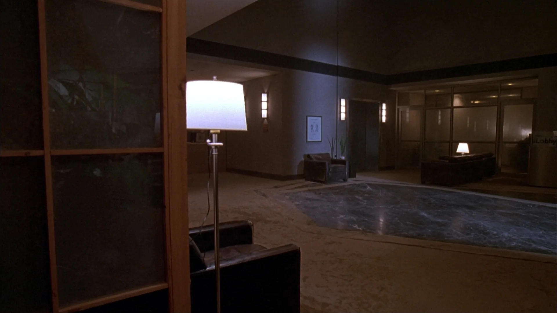 Empty lobby corridor at night. No signage.