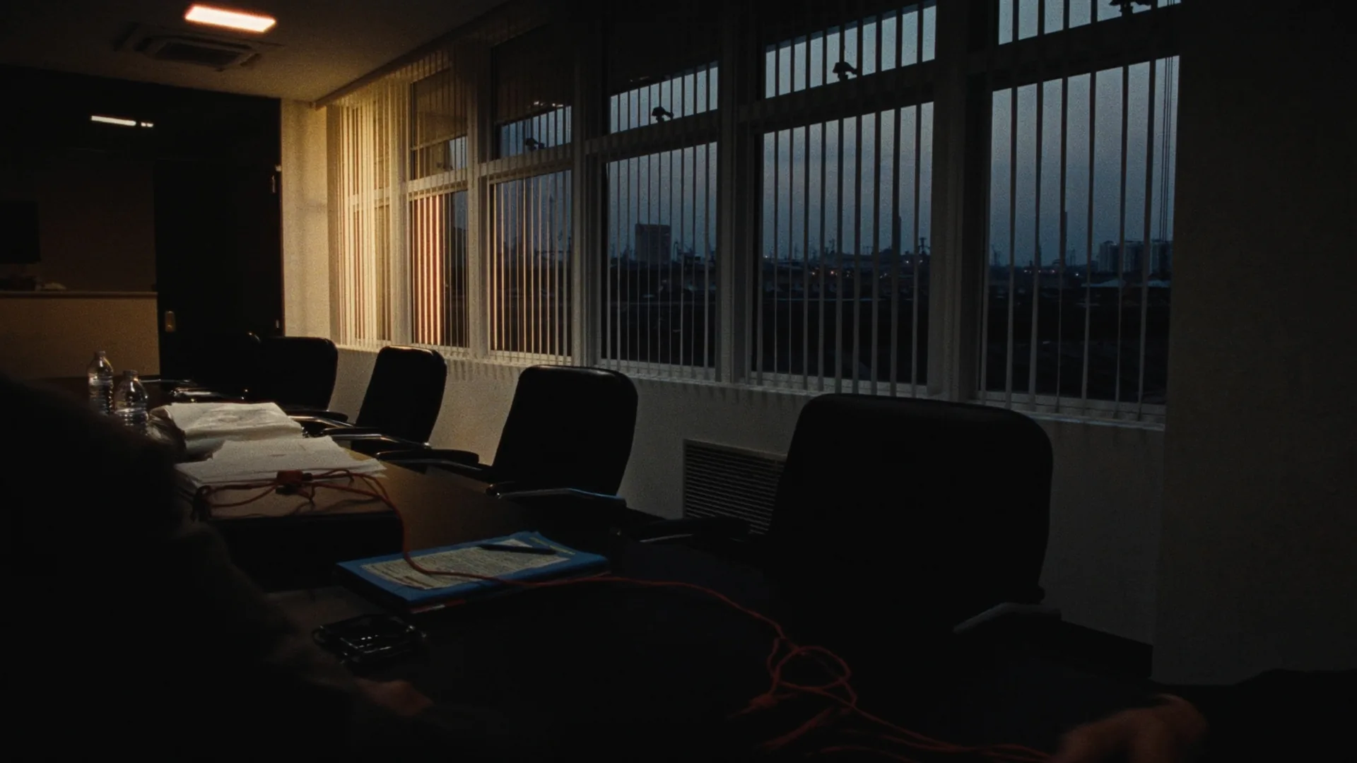 Empty conference table after hours. No screens.